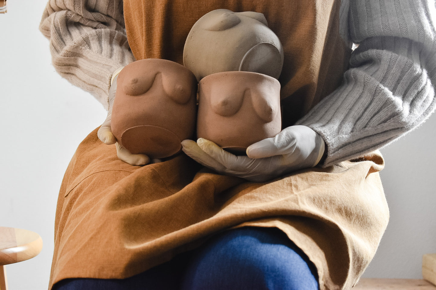 Maker holding plant pot with boobs